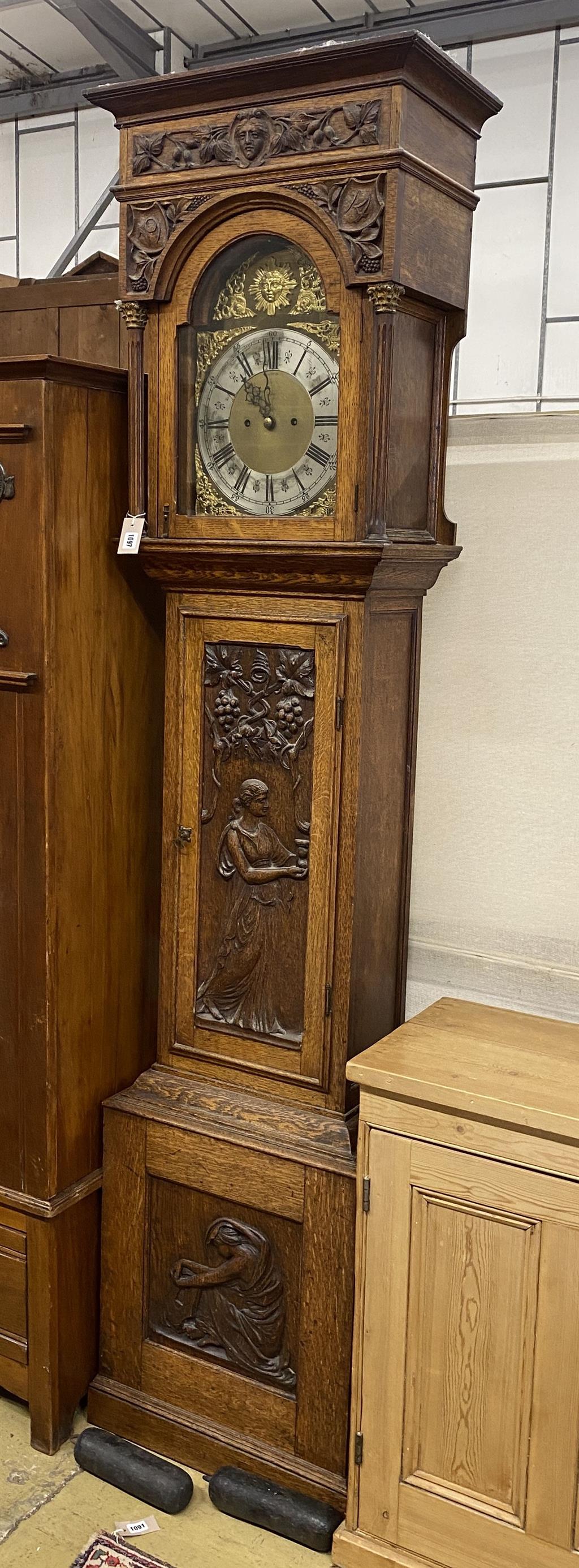 A 1914 carved oak eight day longcase clock, height 230cm